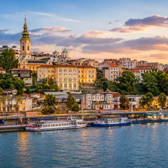 Ville et péniches au bord du fleuve, au crépuscule